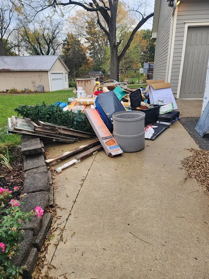 Dumpster being loaded with debris for Residential Dumpster Rental in Warren